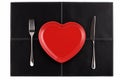 Empty red heart plate knife fork on black leather