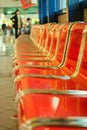 Empty red metal seats at airport hall Royalty Free Stock Photo