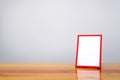 Empty red photo frame on wooden table with copy space, picture m