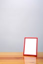 Empty red photo frame on wooden table with copy space, picture m