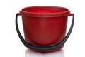 empty red plastic bucket with black handle on white background Royalty Free Stock Photo