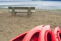 Empty red plastic recreational kayaks for rent or hire, stored on sandy beach after hours on a rainy day. Crescent Beach, Surrey, Royalty Free Stock Photo