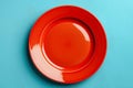 Empty red plate on blue background, intermittent fasting concept. Royalty Free Stock Photo