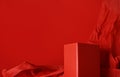 Empty red rectangular podium on red background with crumpled paper Royalty Free Stock Photo