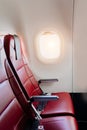 empty red seats for passengers in the cabin of the aircraft. Economy class. Royalty Free Stock Photo