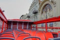 Empty red seats of red double decker tourist bus .No travellers and visitors for city tour in nasty cloudy day Royalty Free Stock Photo