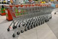 Grocery baskets are at the entrance to the store. Empty baskets in a row, supermarket interior. Royalty Free Stock Photo