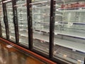 Empty refridgerated shelves after hording of food from supermarkets Royalty Free Stock Photo