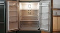 Empty refrigerator with open doors showcasing interior lighting in a modern kitchen Royalty Free Stock Photo
