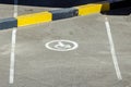 Empty reserved parking space in car park with wheelchair symbol