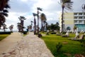 Empty resort place on the seaside with hotel buildings and palm trees in low season