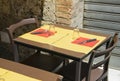 Empty restaurant chairs and table in the old Italian street Royalty Free Stock Photo