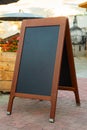 Empty restaurant menu blackboard on the street, menu chalkboard mockup, menu board template Royalty Free Stock Photo