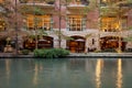 Empty restaurant on the river with cypress trees decorated with Christmas lights