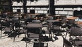 Empty restaurant summer terrace with tables and chairs. Reastaurant tables waiting for customers at an outdoor terrace. Royalty Free Stock Photo