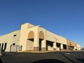 Empty retail building with security gate clear blue sky Royalty Free Stock Photo