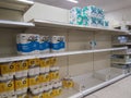 Empty retail shop shelves in supermarket. Low supplies due to stockpiling by customers consumers due to covid 19 coronavirus