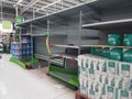 Empty retail shop shelves in supermarket.  Low supplies due to stockpiling by customers consumers due to covid 19 coronavirus Royalty Free Stock Photo