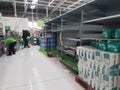 Empty retail shop shelves in supermarket.  Low supplies due to stockpiling by customers consumers due to covid Royalty Free Stock Photo