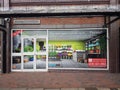 Empty retail shop unit with to let fake window display in high street setting Royalty Free Stock Photo