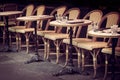 Empty retro tables and chairs on a outdoor cafe terrace in Paris France