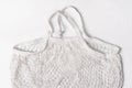 Empty reusable cotton shopping string bag on white background. Eco friendly net bag or shopper. Rejection of plastic, zero waste,