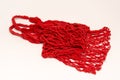 Empty reusable red shopping string bag on white background. Zero waste concept. Eco friendly lifestyle. Top view