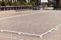 Empty riding sand arena of a horse farm. Concept of sport, competition Royalty Free Stock Photo