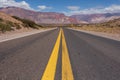 An empty road in Argentina leading towards the border with Chile in the Andes mountain range. Royalty Free Stock Photo