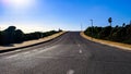 empty road with asphalt, hedges and street lamps. near Binibequer Vell, Menorca, Balearic Islands, Spain