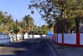 Empty road with beautiful palm tree on road and government offices and building. old city road of Diu Fort road, Royalty Free Stock Photo