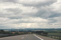 Empty road on a cloudy day. Traveling close to home by car. European autobahns Royalty Free Stock Photo