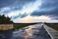 An empty road with a dramatic sky with clouds in the background Royalty Free Stock Photo