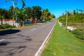 Empty road and green tropical roadside. South Asia countryside travel photo. Agricultural landscape