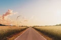 Empty road, landscape - sunset sky and wind turbines Royalty Free Stock Photo