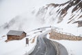 Empty road leading through scenic countryside, Snow & fog at Grossglockner mountain, Austria