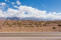 An empty road leading towards the Andes mountain range. It connects the cities Mendoza, Argentina to Santiago, Chile. Royalty Free Stock Photo