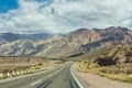 An empty road leading towards the Andes mountain range. It connects the cities Mendoza, Argentina to Santiago, Chile. Royalty Free Stock Photo