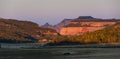 An empty road leading into Zion National Park during sunrise with an old truck in the foreground and the canyon walls and trees Royalty Free Stock Photo