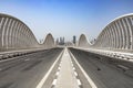 An empty road on a Meydan bridge with city view on background in Dubai