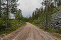 Empty road in the middle of forest in Luosto Lapland Finland Royalty Free Stock Photo