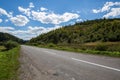 Empty road and mountains on background of the cloudy sky Royalty Free Stock Photo