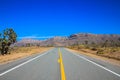 Empty road with mountains behind in Arizona, USA