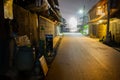 Empty road at night time beside wooden house