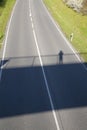 Empty road with shadow of a person on a bridge Royalty Free Stock Photo
