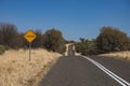 Empty road with a sign "floodway" on the left on a sunny day