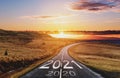 2021 and 2020 on the empty road at sunset. New Year concept Royalty Free Stock Photo