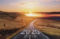 2020 and 2019 on the empty road at sunset. New Year concept Royalty Free Stock Photo