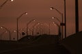 Empty road surrounded by street lamps in the night during the quarantine Royalty Free Stock Photo