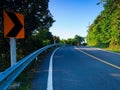 Empty road by trees against clear blue sky Royalty Free Stock Photo